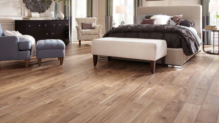 warm wood look laminate flooring in a stylish bedroom