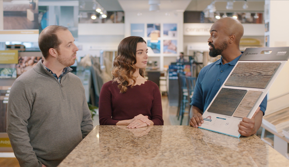 Two customers talking to a salesperson at Imperial Flooring America