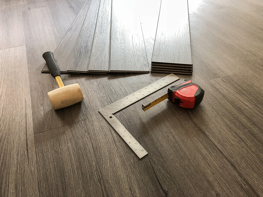 Installation tools on a hardwood flooring surface. 